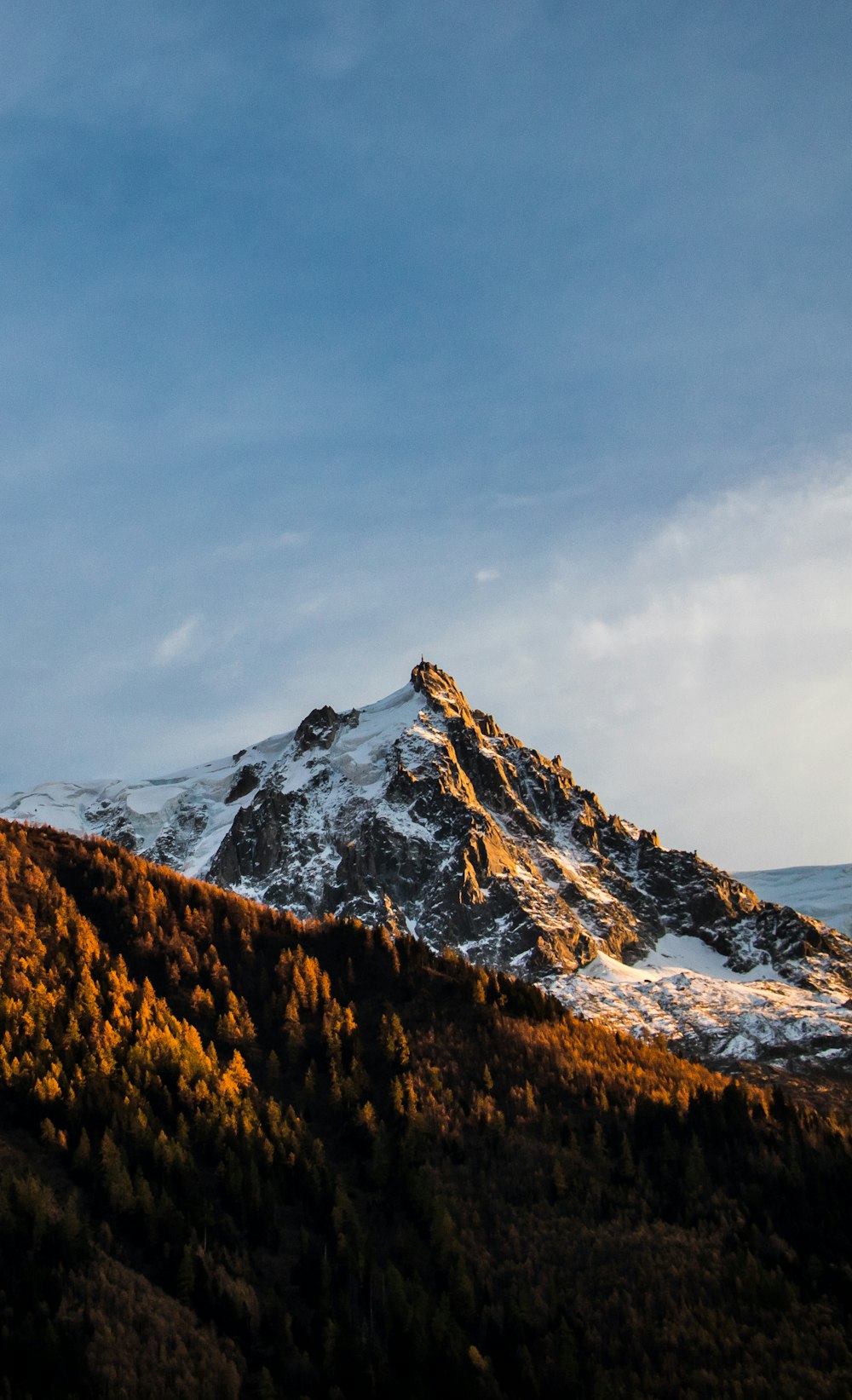 snow covered mountain under cloudy sky during daytime