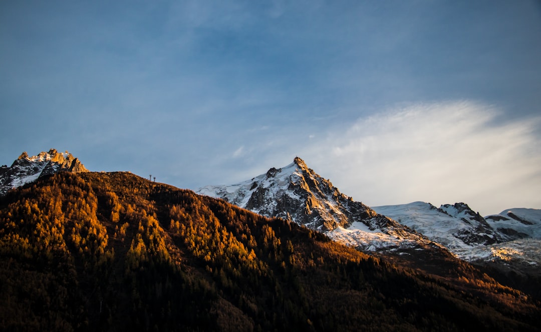 snow covered mountain under cloudy sky during daytime