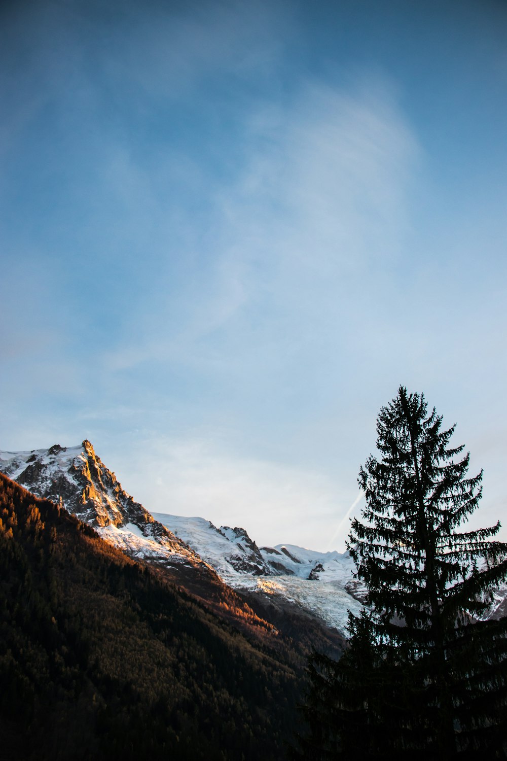 snow covered mountain under cloudy sky during daytime