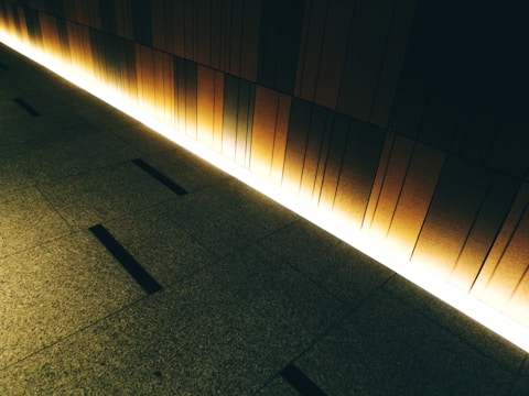 A warm-toned wooden room divider with intricate geometric patterns softly lit by natural sunlight.