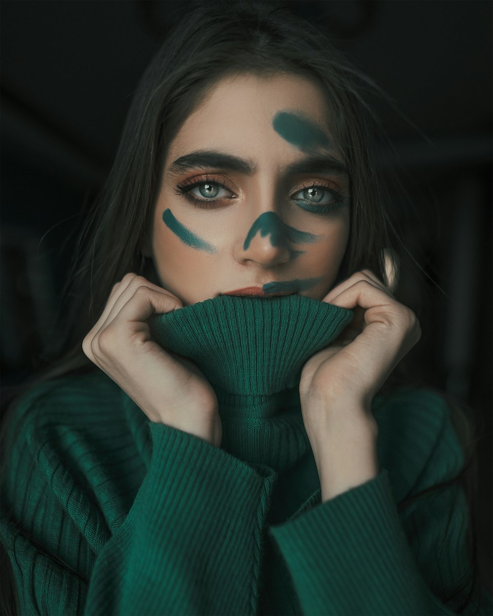 woman in green sweater with blue eyes