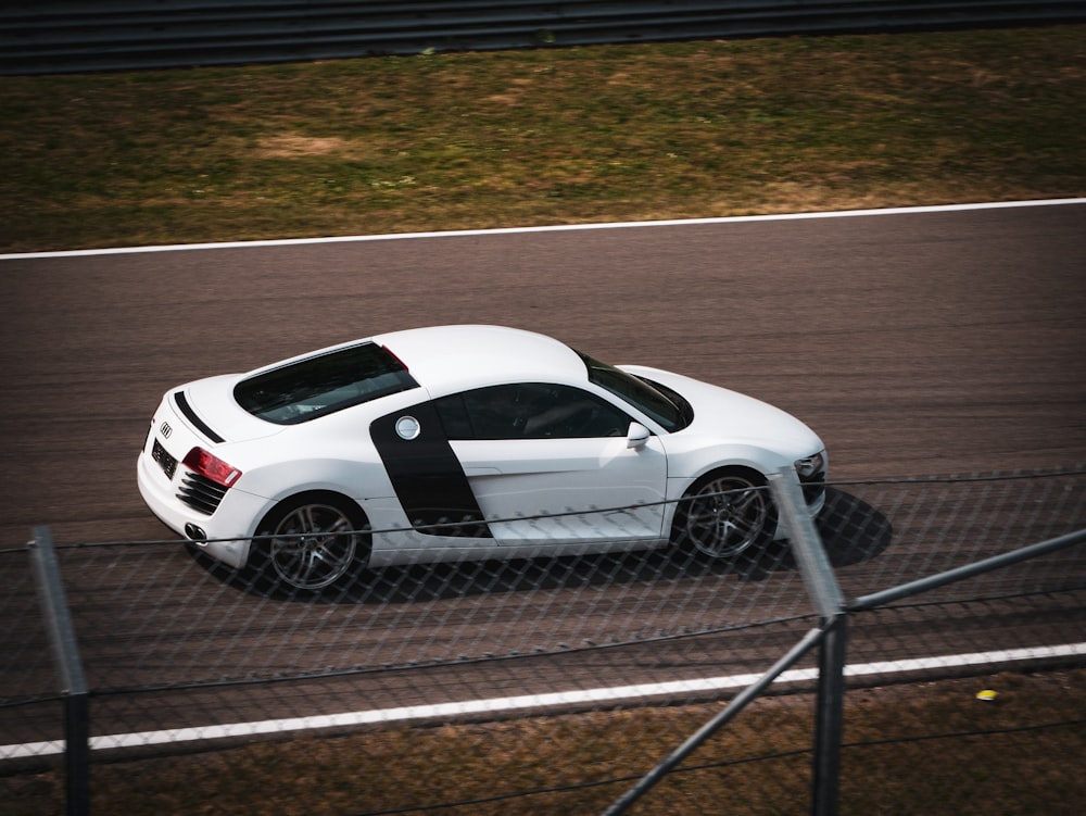 white porsche 911 on track field during daytime