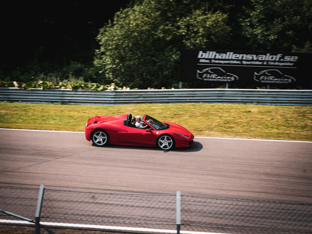 red ferrari 458 italia on road during daytime