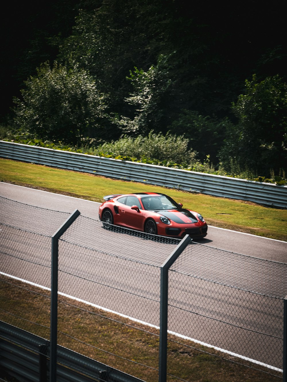 red and black sports car on road during daytime