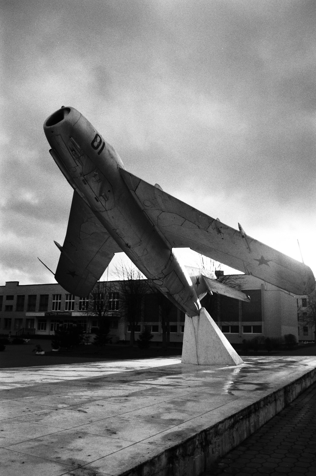 grayscale photo of airplane in the city