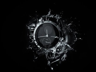 A luxury diver’s watch submerged halfway in crystal-clear ocean water, highlighting its rugged design.