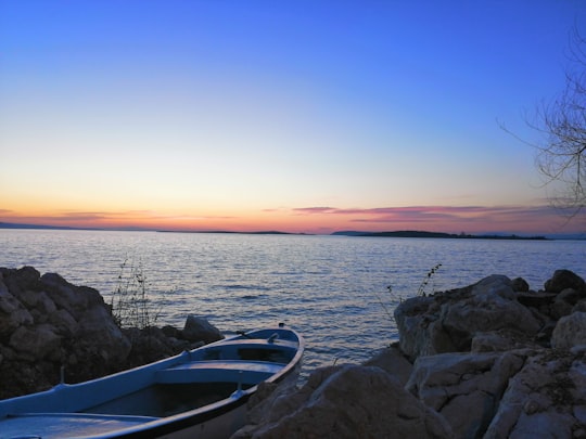 white and blue boat on sea during sunset in Gölyazı Turkey