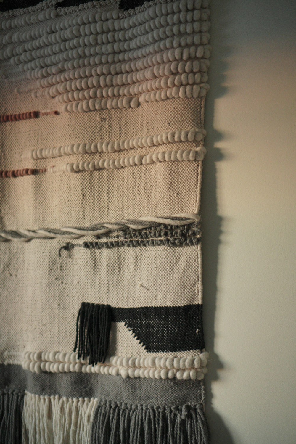 a close up of a woven wall hanging