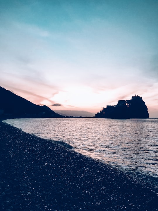 silhouette of mountain beside body of water during daytime in El Hoceima Morocco