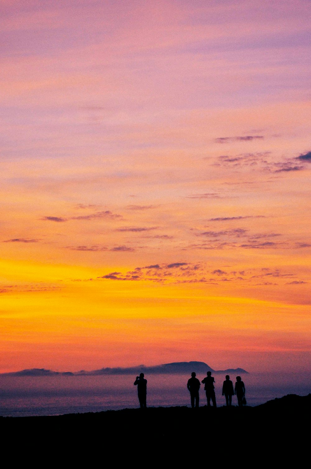 silhouette of people on mountain during sunset