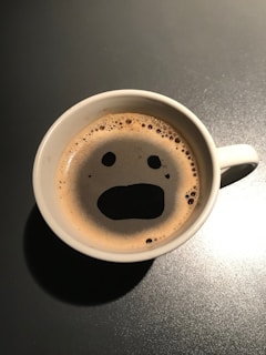 Close-up of a coffee mug featuring a popular meme design.