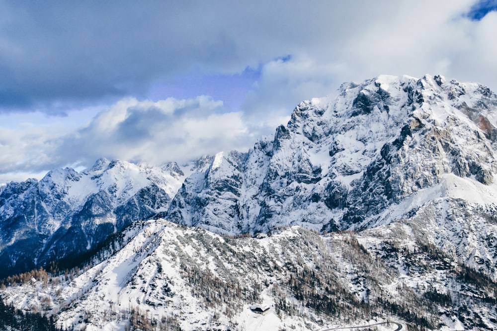 snow covered mountain under cloudy sky during daytime