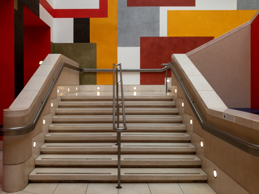 stainless steel hand rail on white and red concrete staircase