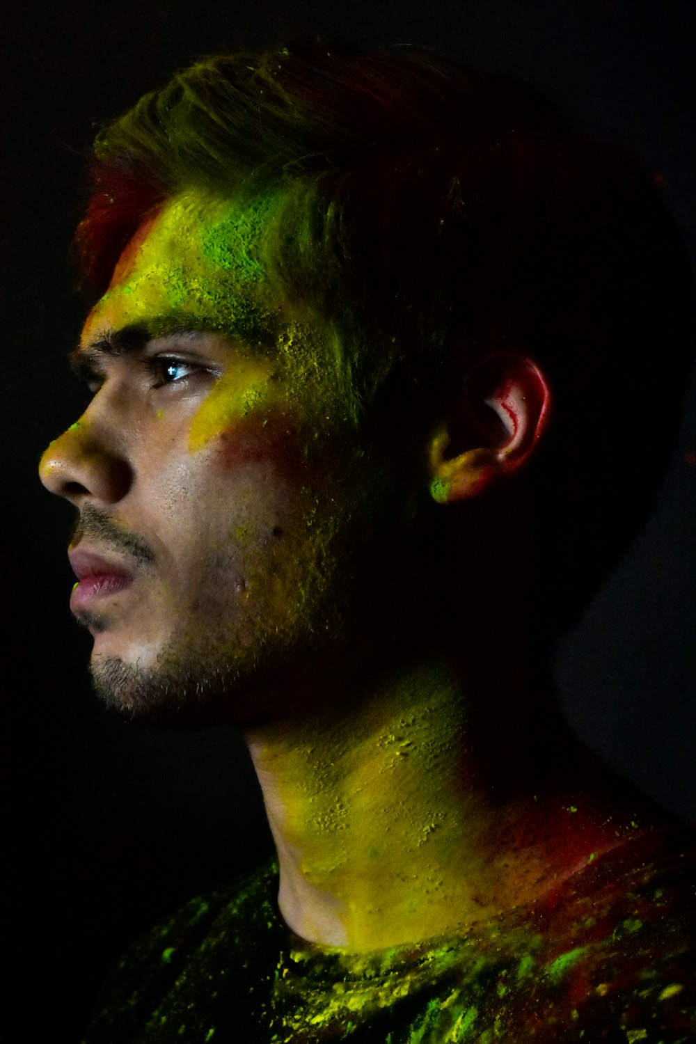 man with green and yellow face paint