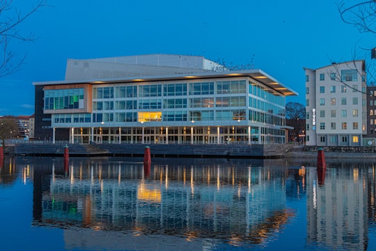 white concrete building near body of water during daytime in Karlstad Sweden