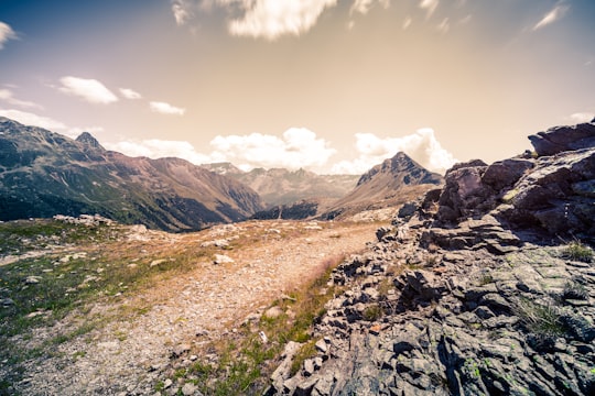 rocky mountain under blue sky during daytime in Berninapass Switzerland