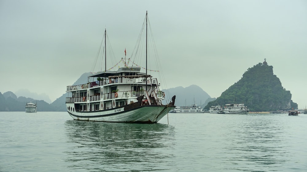 white and green boat on sea during daytime