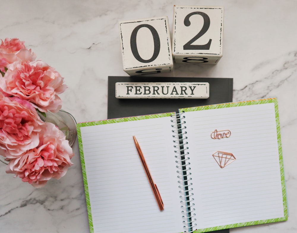 white and black calendar with red pen and white and black box