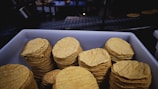 brown round biscuits on blue tray