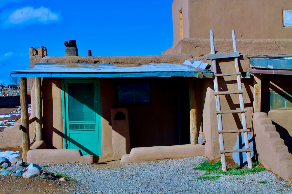 brown wooden house with blue wooden door