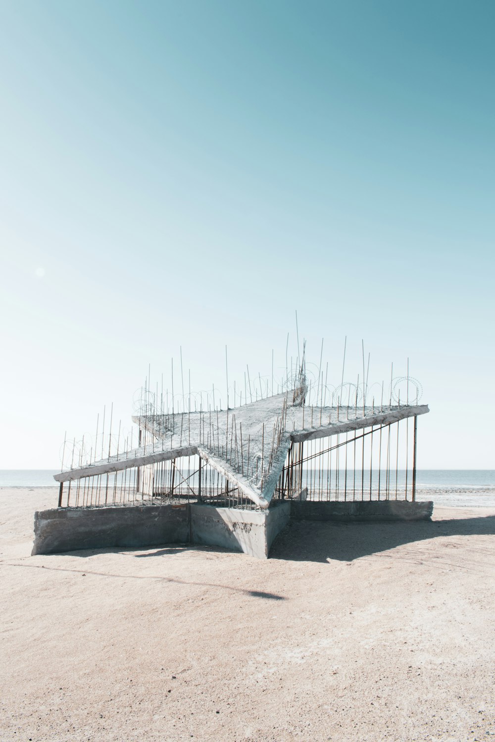 gray wooden bridge on sea during daytime