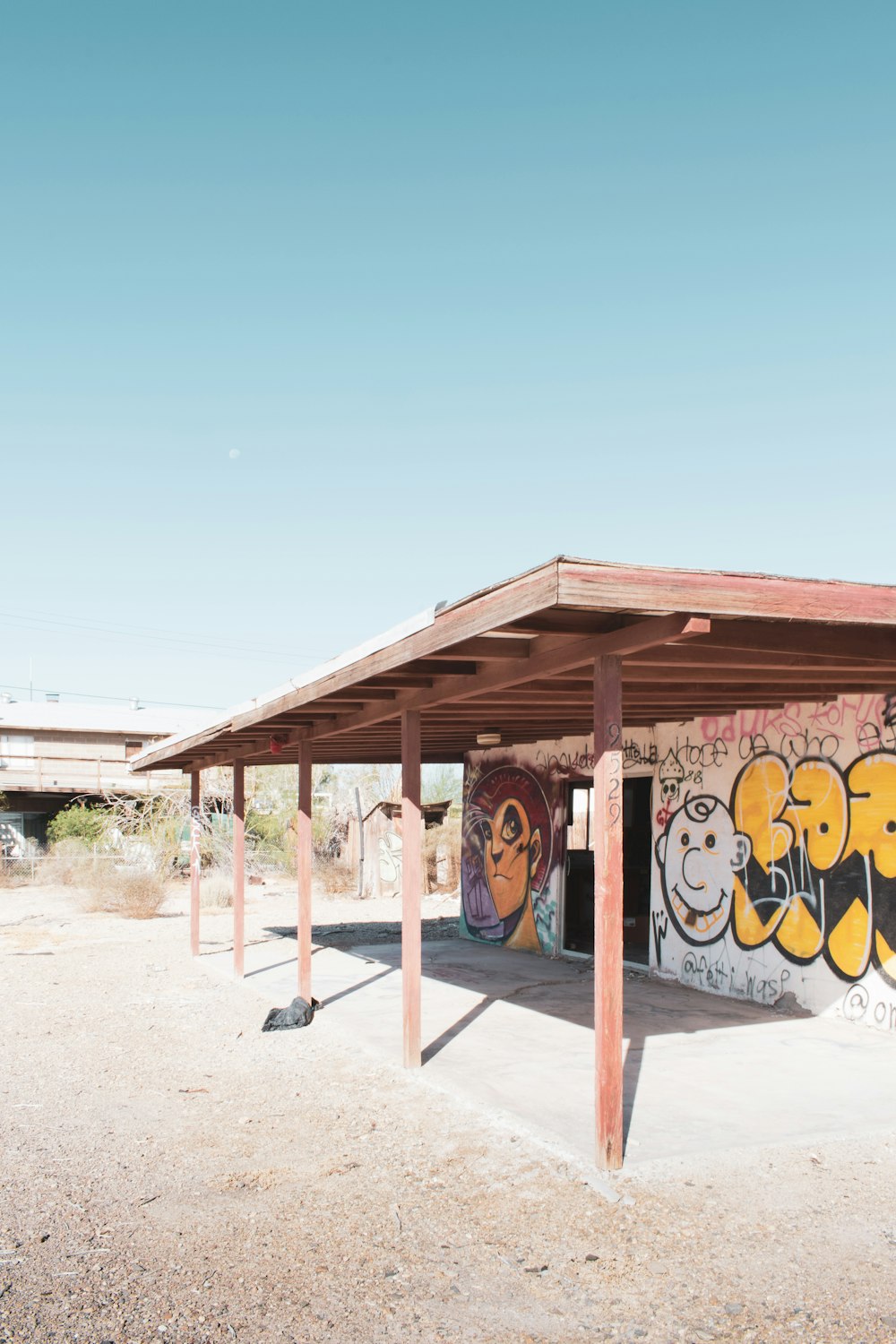 brown wooden house with graffiti