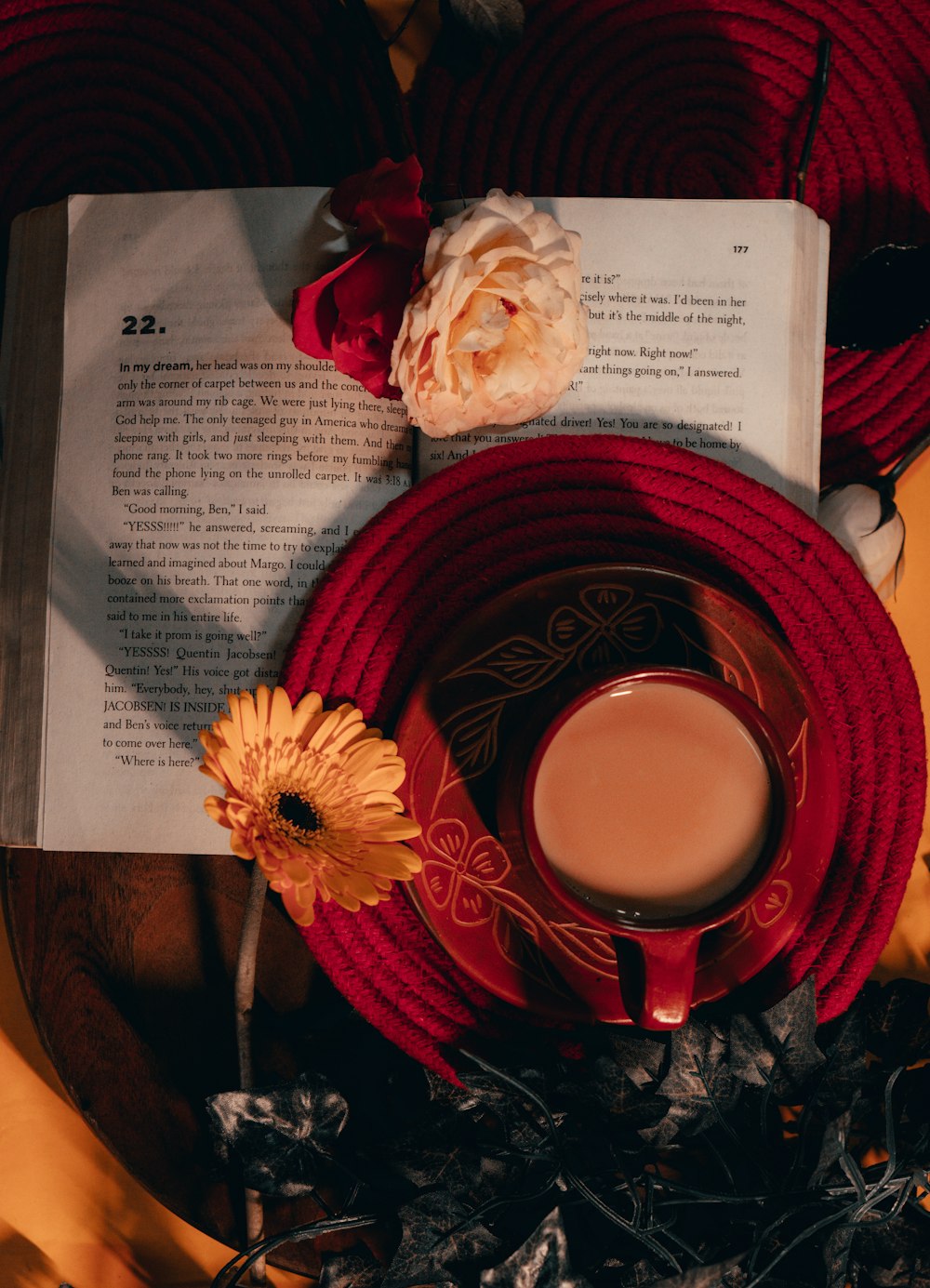 red and white ceramic mug on red saucer