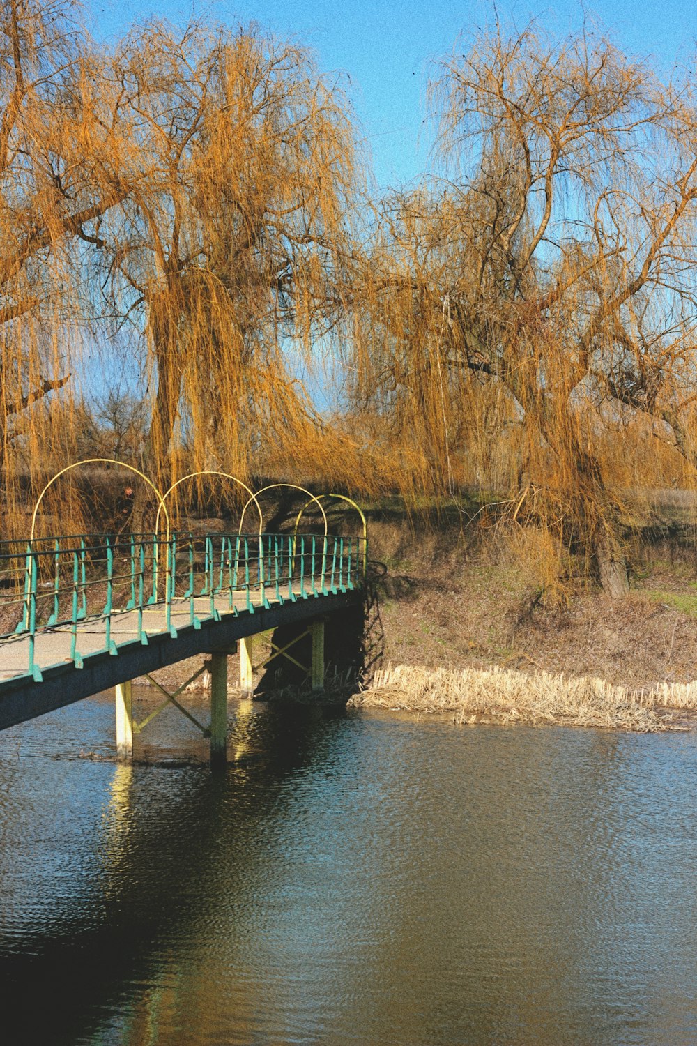 brown wooden bridge over river