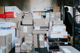 brown cardboard boxes on black plastic crate