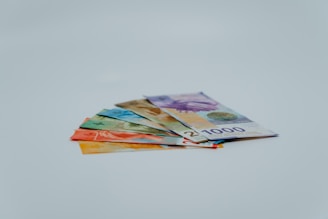 stack of banknotes on white surface