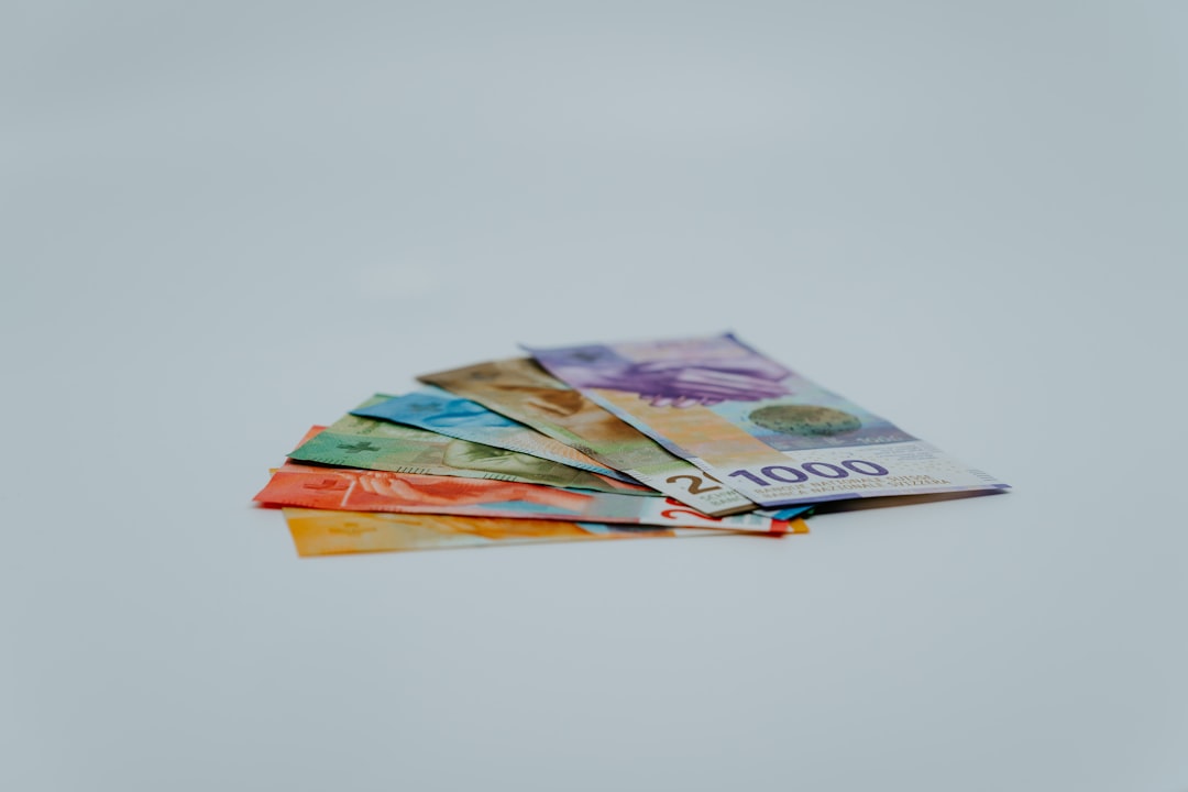 stack of banknotes on white surface