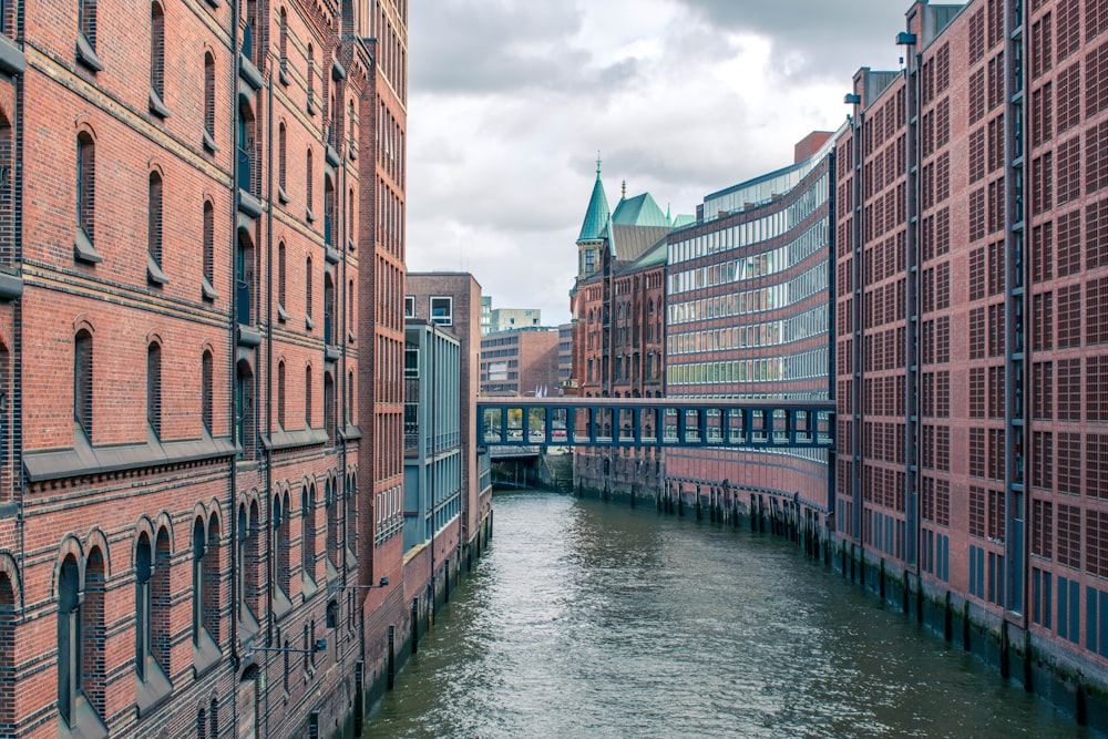 brown concrete building beside river during daytime