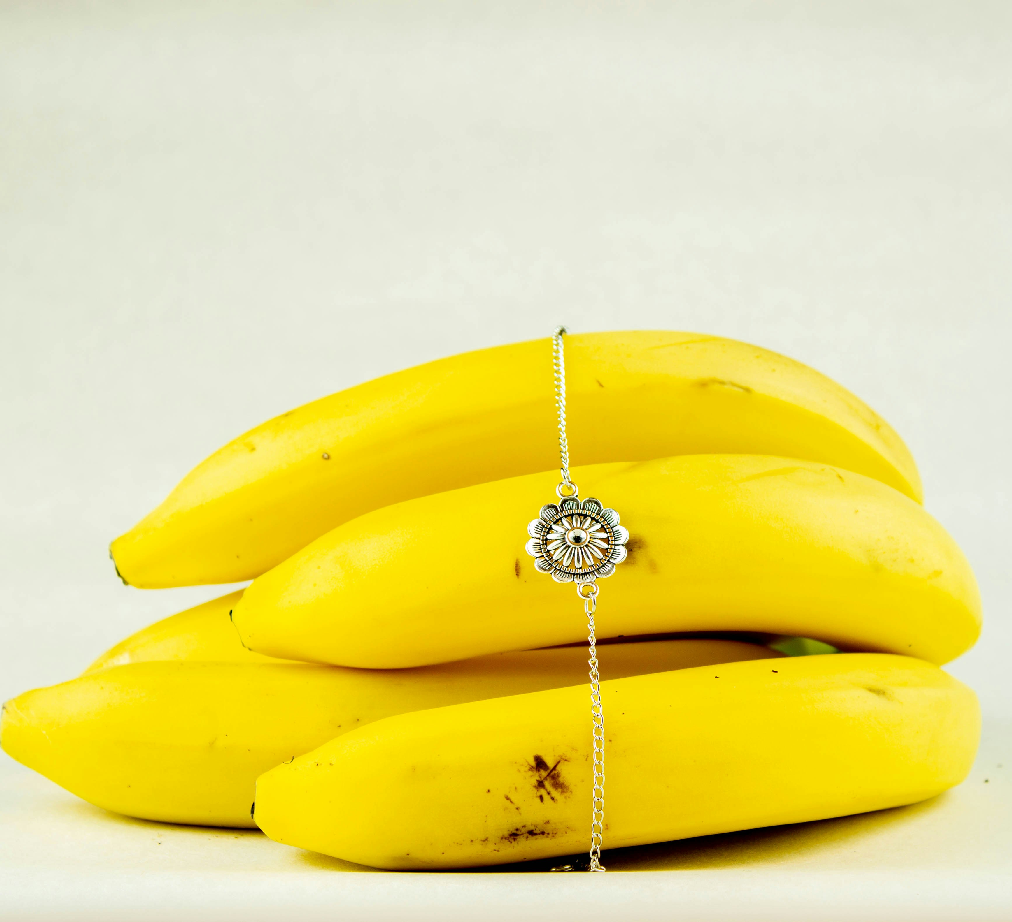 yellow banana fruit on white surface