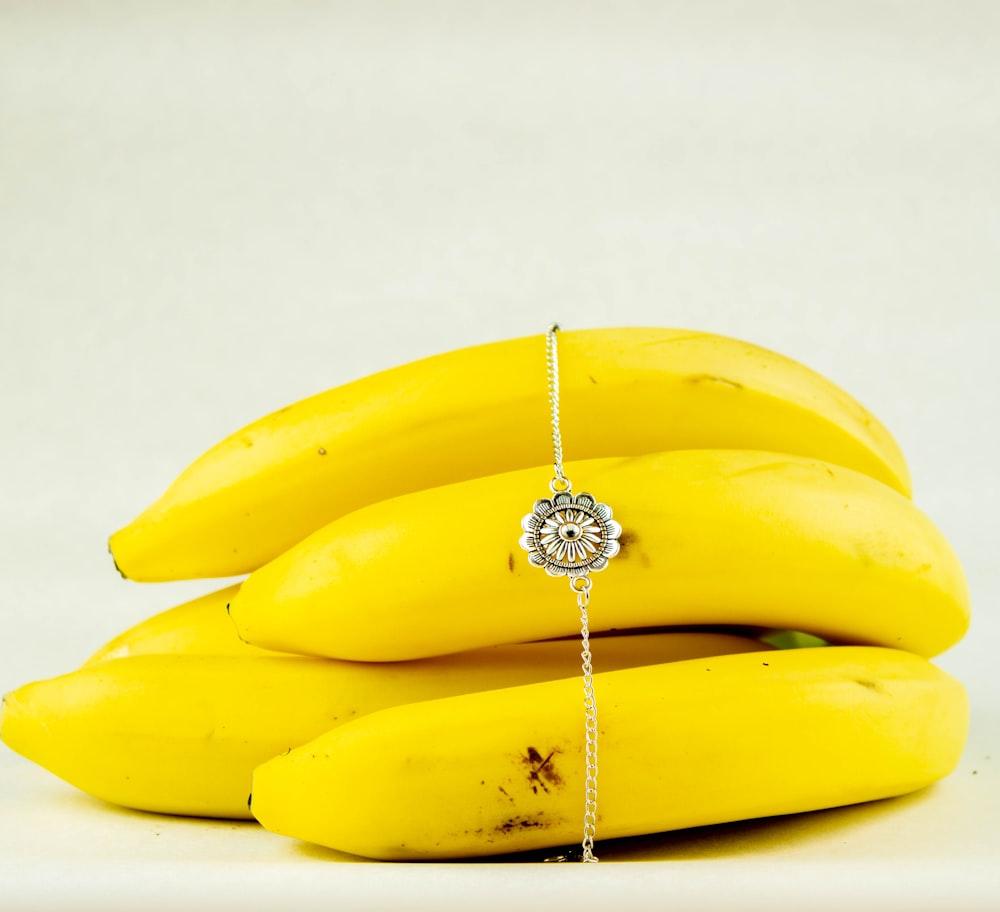 yellow banana fruit on white surface