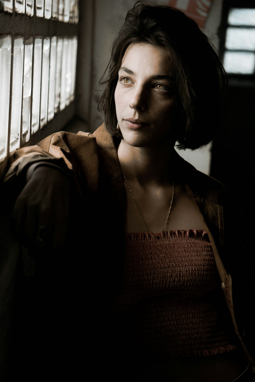 woman in brown cardigan and red knit shirt