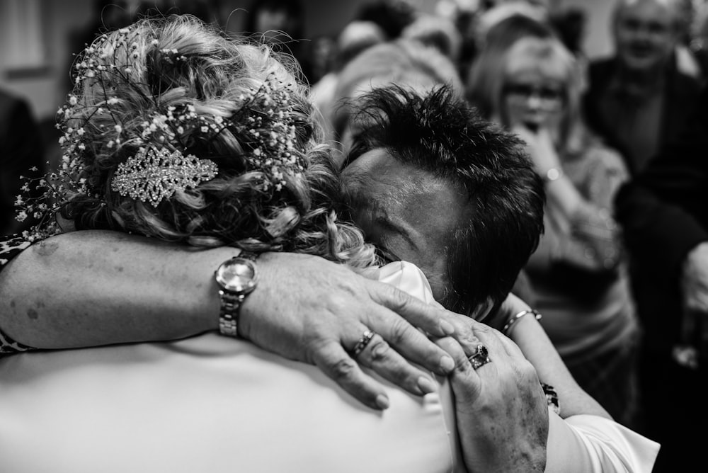 grayscale photo of man and woman holding hands