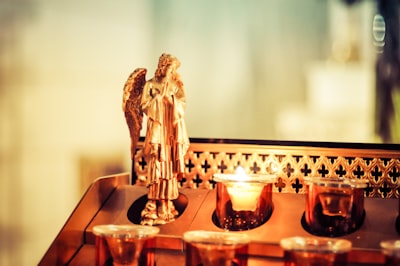 gold buddha figurine on brown wooden table st. patrick zoom background