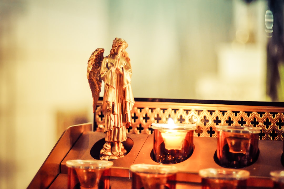 gold buddha figurine on brown wooden table