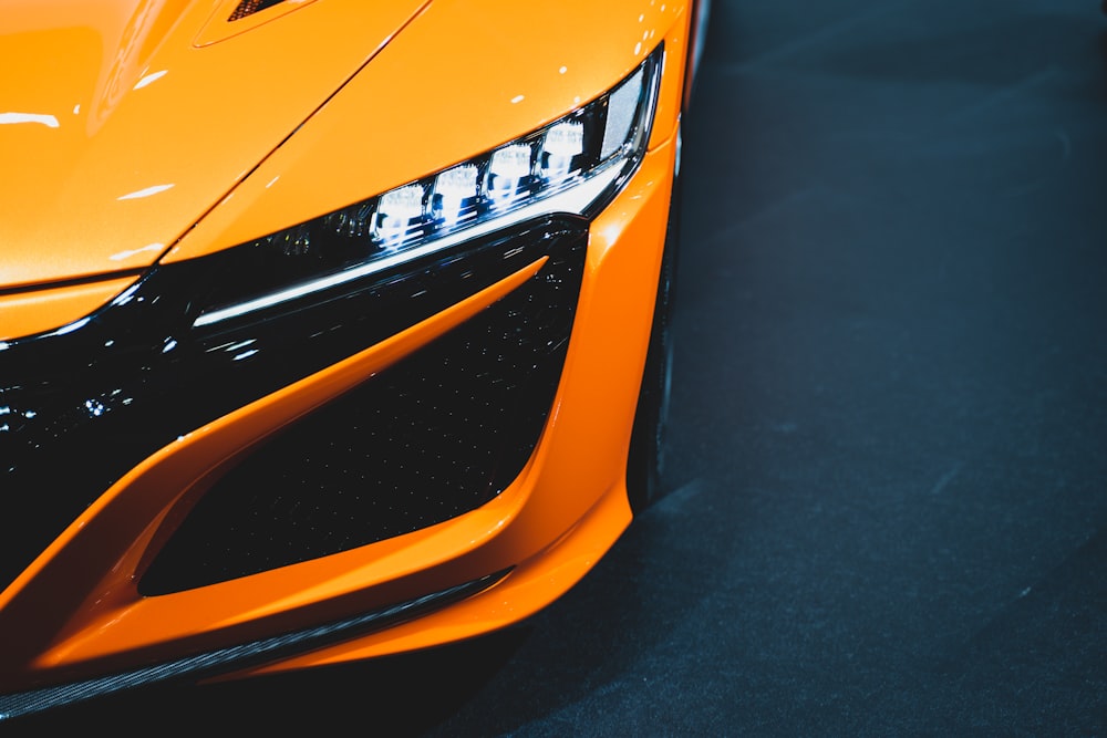 orange and black car on black asphalt road