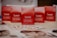 Several red boxes with 'Guinot Institut Paris' and 'Programme de Soins' written on them are arranged on a table. In the foreground, there are brochures displaying images of faces spread out on the table.