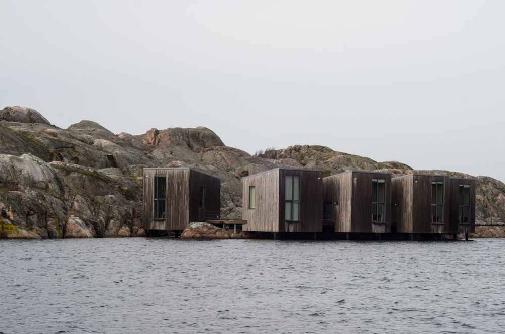 brown wooden houses on sea shore during daytime