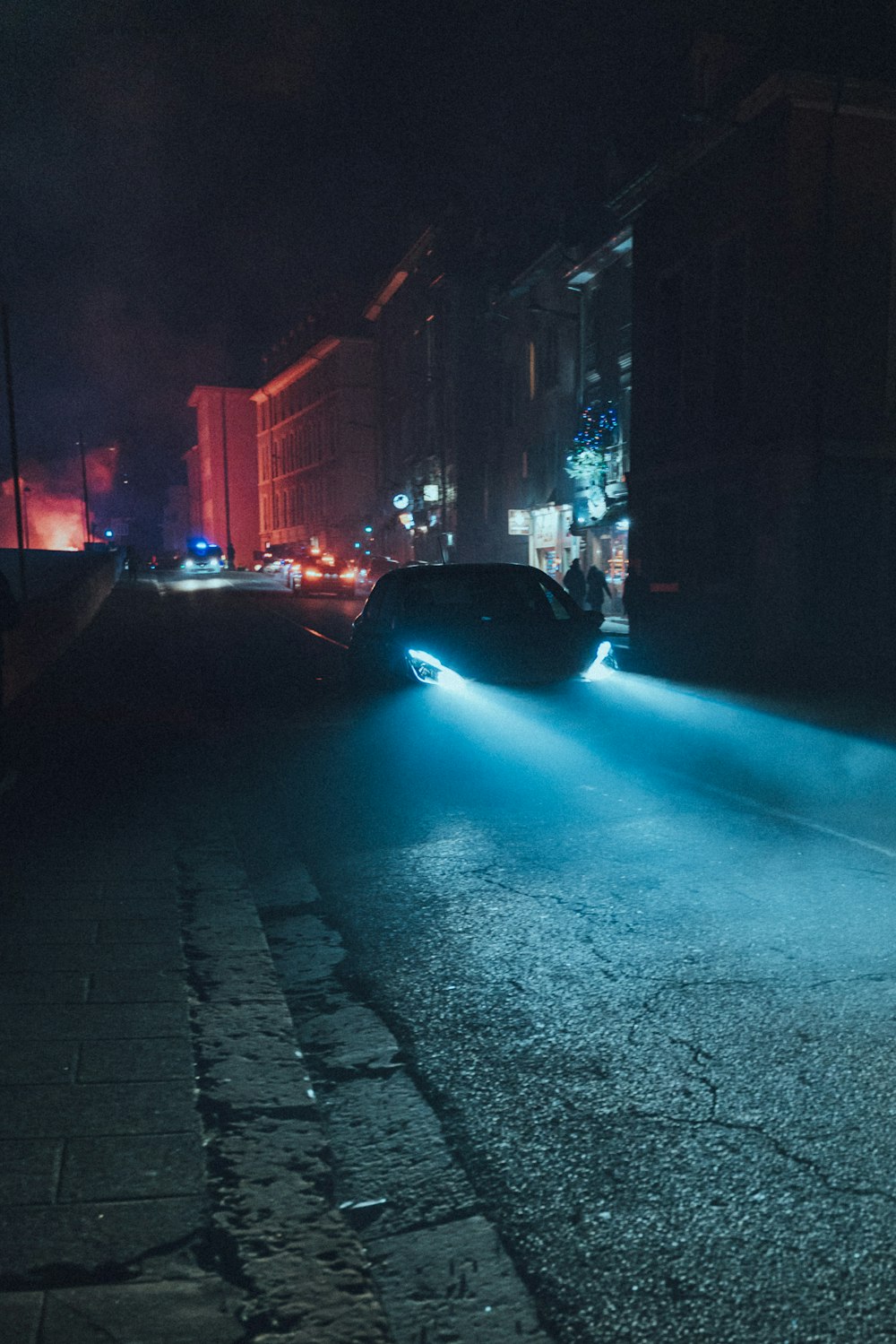 black car on road during night time