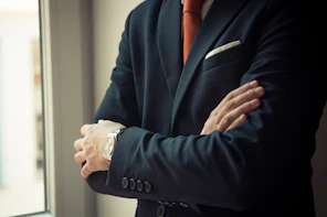 man in black suit jacket wearing silver watch