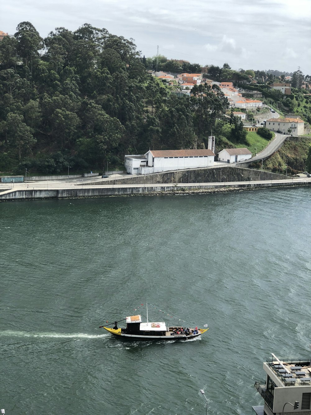 yellow and black boat on body of water during daytime