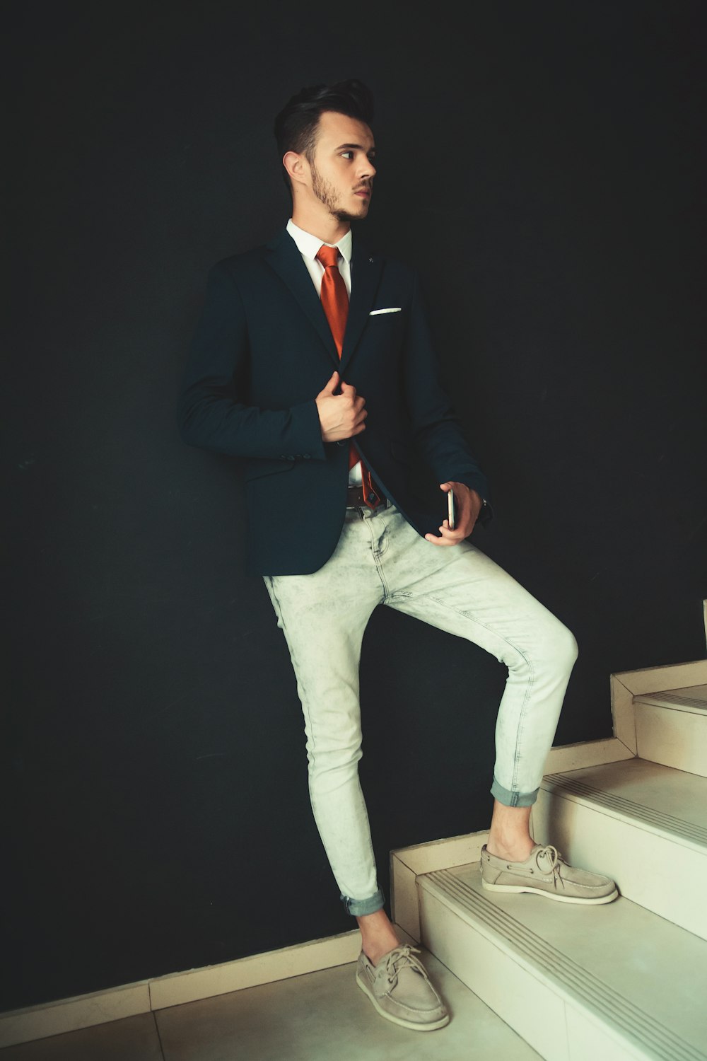 man in black blazer and white pants