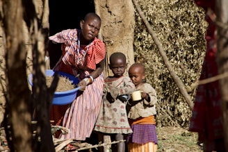 girl in red and white stripe shirt standing beside girl in pink and white stripe shirt