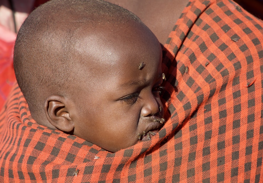 baby in red and white checkered shirt