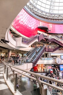 people walking inside building with escalator