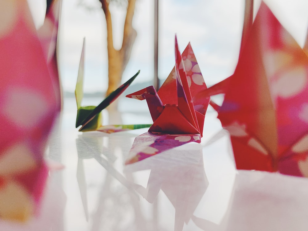 red paper boat on white table