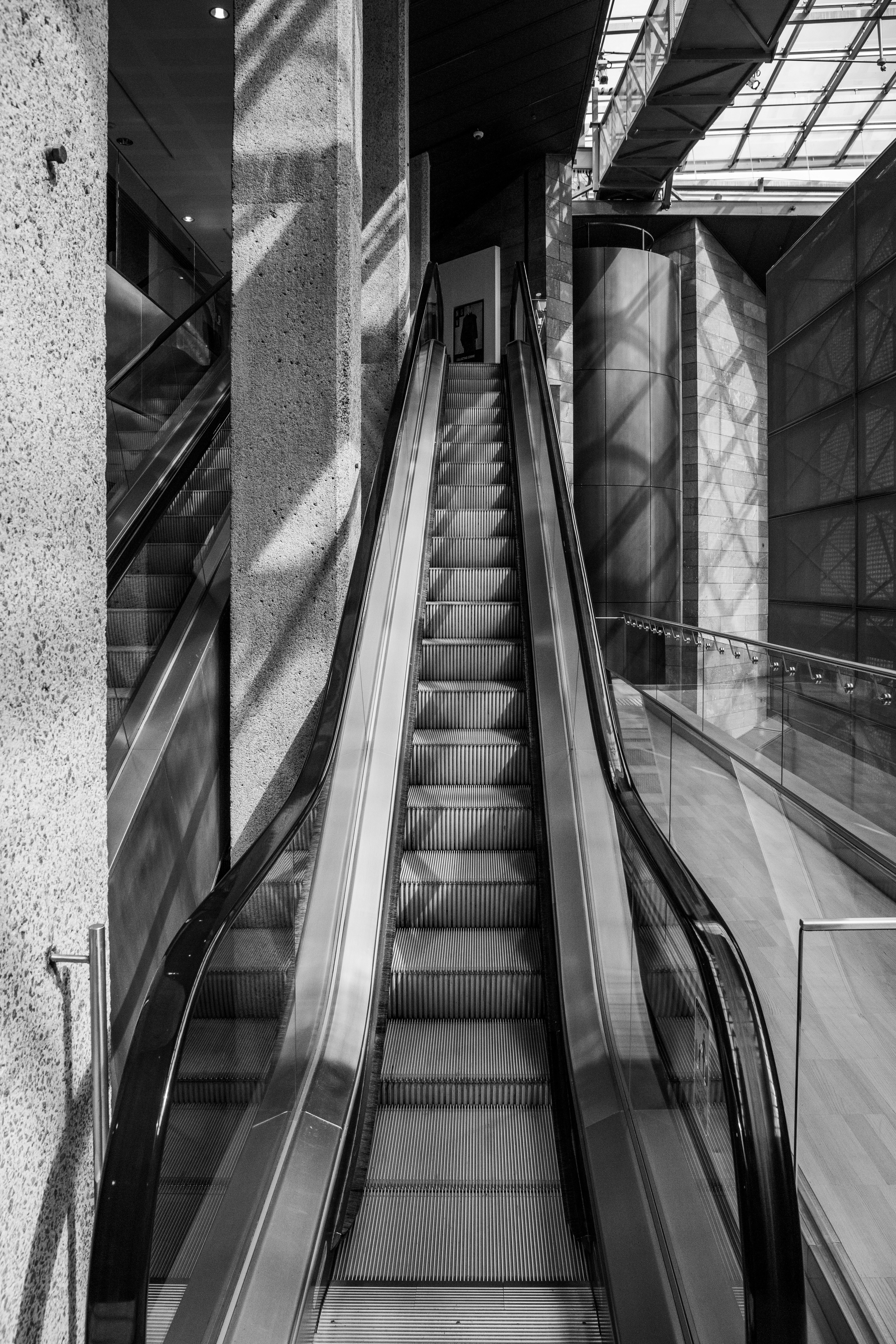 grayscale photo of a escalator